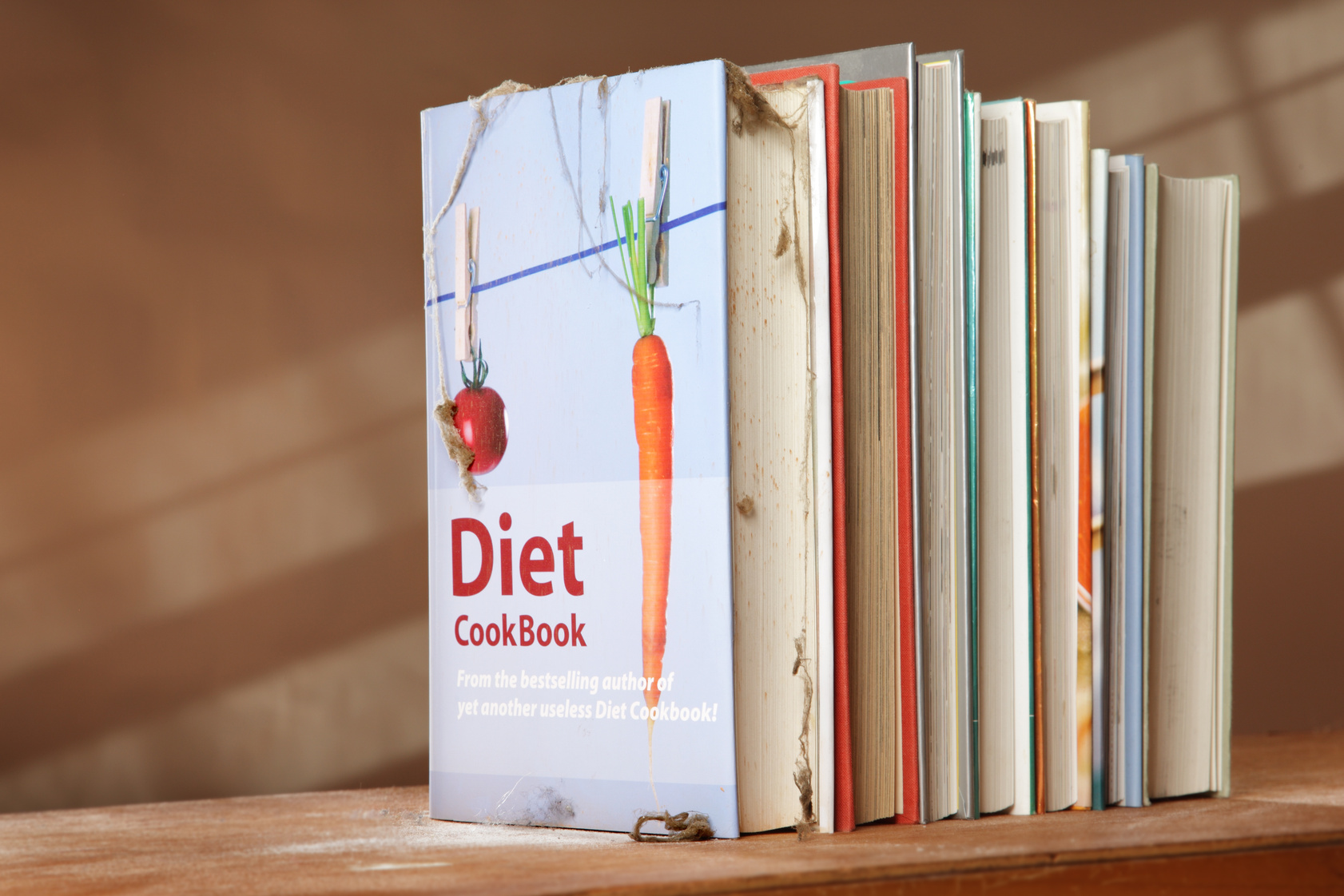 Diet cookbook on shelf with other books